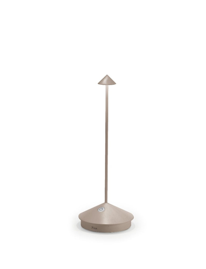 The Pina Pro Rechargeable Lamp by Ai Lati for Zafferano features a sleek and small body and wide base to anchor the lamp. Its clean design perfectly suits small settings offering a crisp and bright light to a space. Features a die-cast LED lamp with polycarbonate diffuser, 13+ hours of rechargeable battery life, and portable body makes the Pina Pro an excellent accents to a space. Touch-dimmable. Contact charging base with USB cable included. Suitable for indoor or outdoor use.