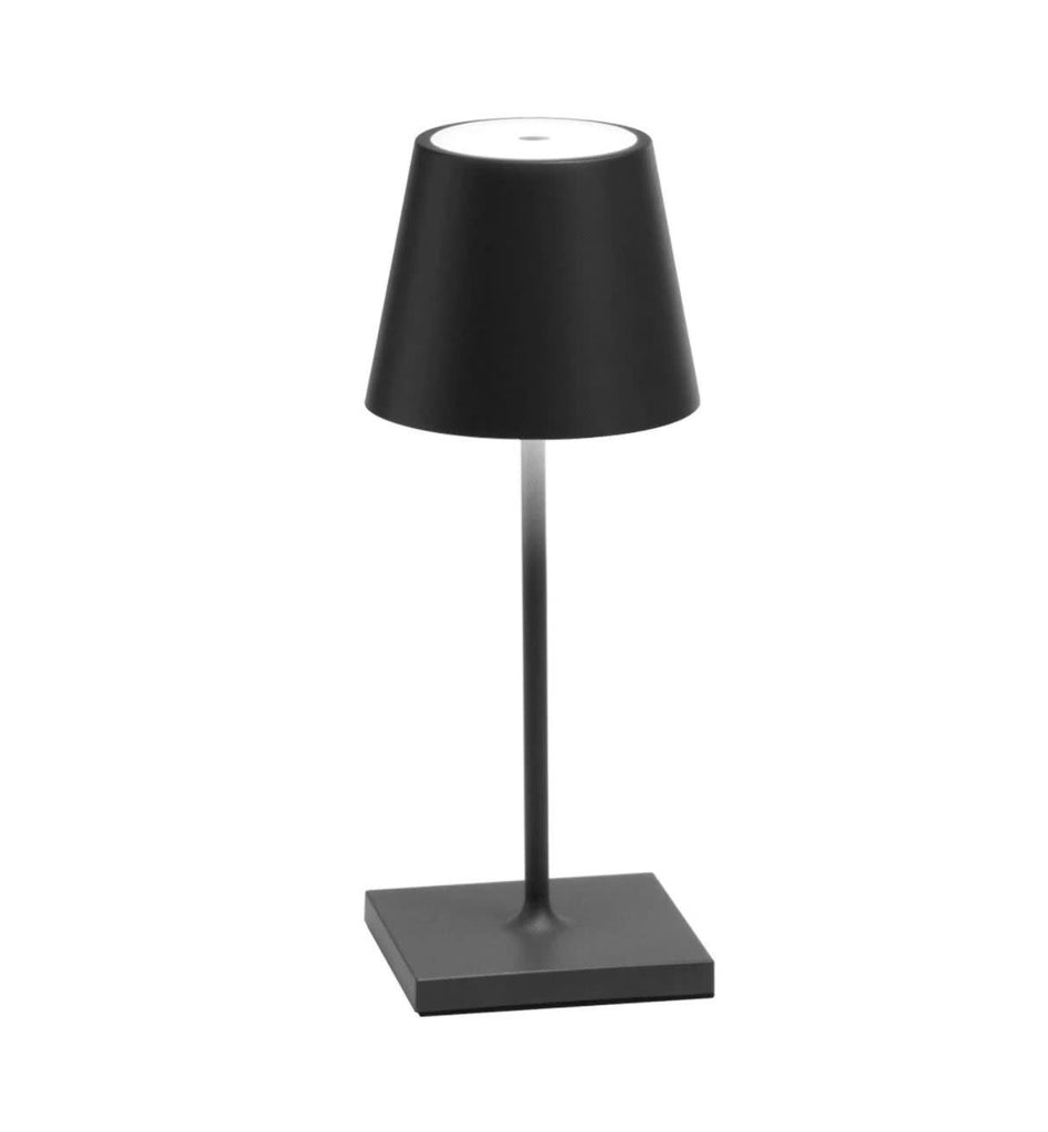 The Poldina Mini Table Lamp by Ai Lati Lights for Zafferano features a sleek and small body and offers a crisp and bright light to its setting. Ideal for indoor and outdoor settings with its 9 hour rechargeable battery life and portable body makes the perfect accent to a space. The fixture is made up of painted aluminium with a polycarbonate diffuser and LED light source. Its square base ensures a sturdy display.