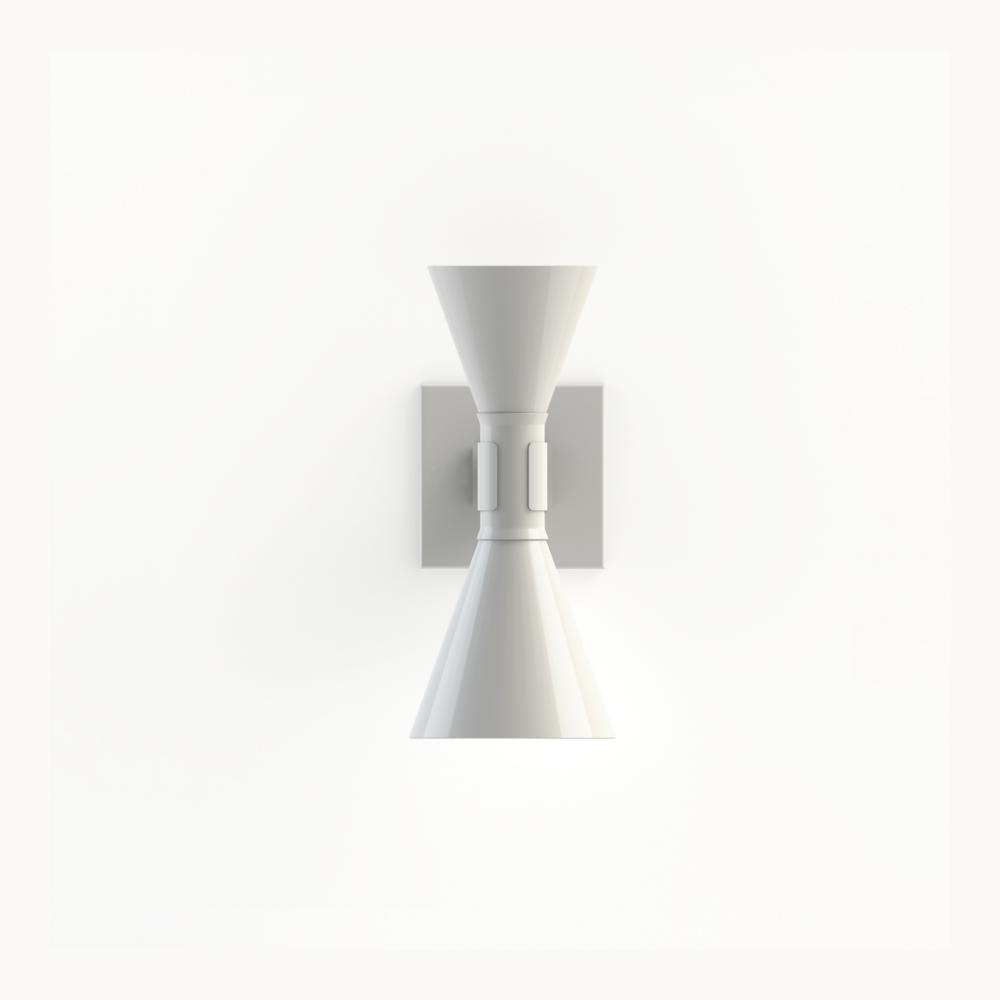 The mini version of the iconic Applique de Marseille, designed by Le Corbusier for his Parisian flat in Rue Nungesser et Coli. This wall lamp provides direct and diffused light through its two cone-shaped lampshades that direct the light up and down, providing homogenous and sharp light beams.