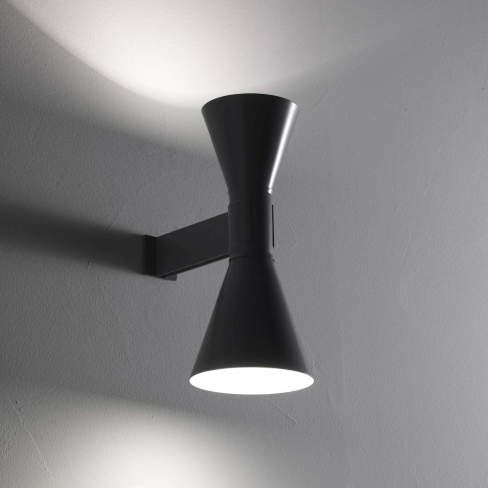 This wall sconce features double emission up and down light, in aluminum painted matte grey, matte white, or black, with white internal diffusers.