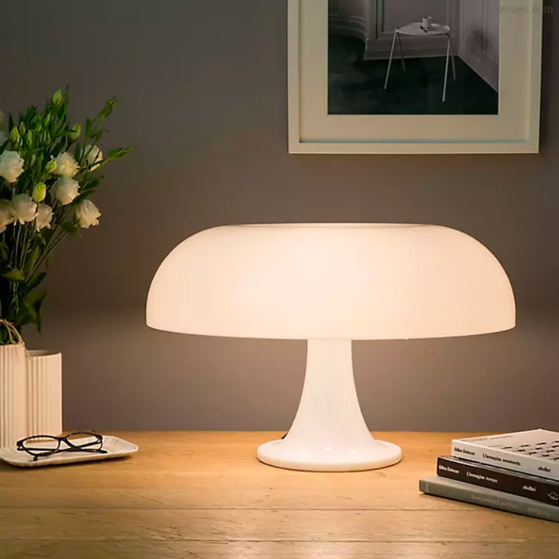 Designed back in 1967 by Giancarlo Mattioli, the Artemide Nesso Table Lamp yet remains very much at home in today's contemporary interiors. Its distinctive mushroom-shaped form is created out of injection-molded ABS resin. It makes a bold statement in modern living rooms or offices in either vibrant Orange or clean, crisp White.