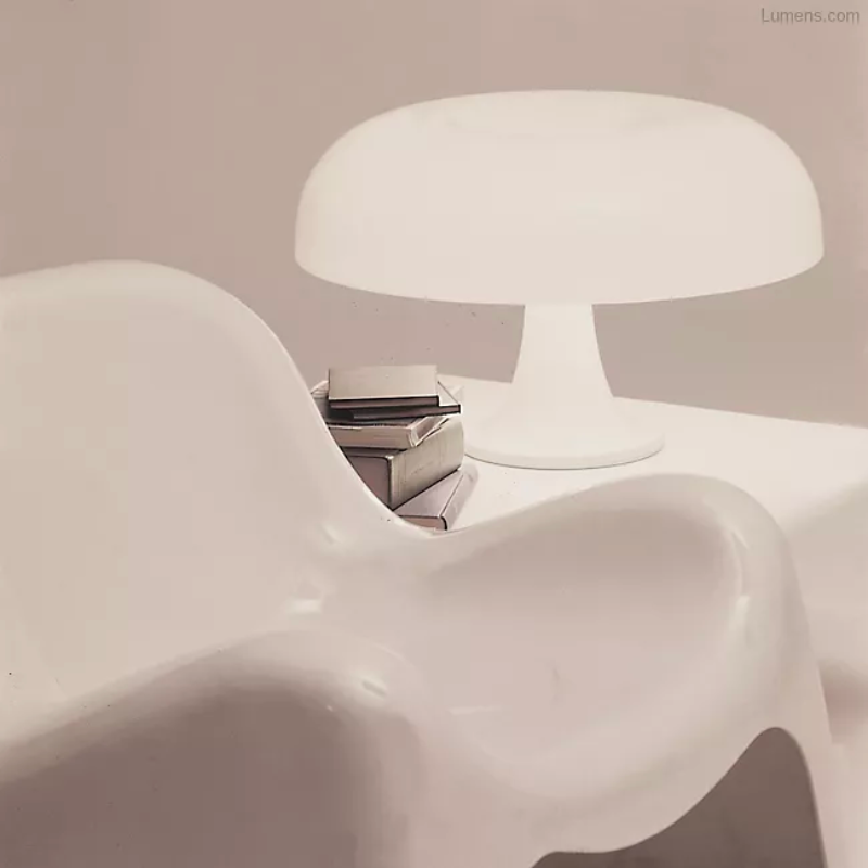 Designed back in 1967 by Giancarlo Mattioli, the Artemide Nesso Table Lamp yet remains very much at home in today's contemporary interiors. Its distinctive mushroom-shaped form is created out of injection-molded ABS resin. It makes a bold statement in modern living rooms or offices in either vibrant Orange or clean, crisp White.