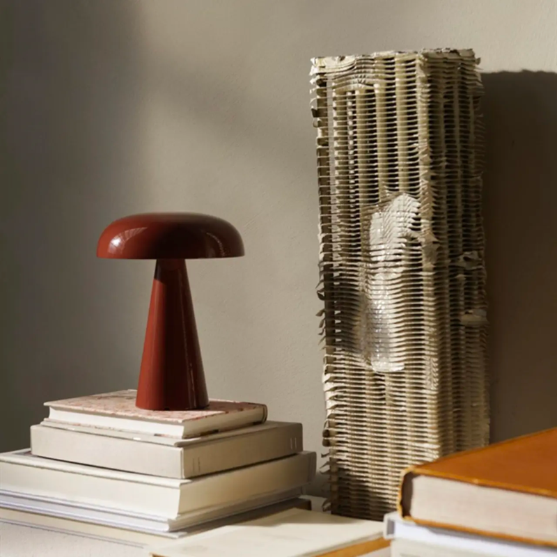 Como SC53, a portable table lamp from Space Copenhagen. Crafted from anodized aluminum, Como’s sturdy base tapers up towards a softy curved, mushroom-shaped shade. This battery-powered lamp can operate for eleven hours at the highest setting, with an extra battery option that allows additional operating. It is easily recharged with a magnetic USB cable or a charging tray.