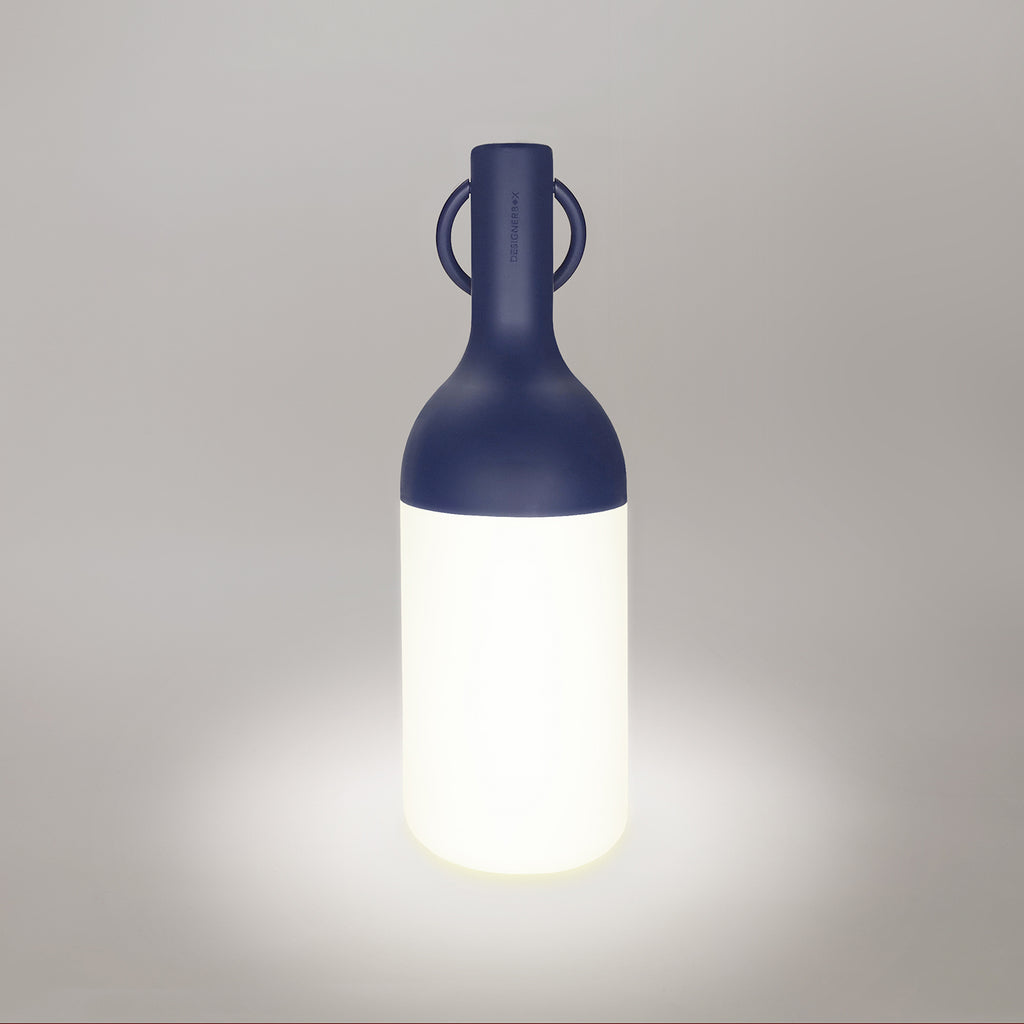 Get ready for the great outdoors with the ELO Rechargeable LED Portable Table Lamp from DesignerBox. Created with an eye toward French design by Bina Baitel, it starts with a handle that flares out into a dome shape, seating weatherproof and dimmable LED lamping inside a cylindrical, translucent shade that blocks excess glare, transforming it into a pleasant glow.