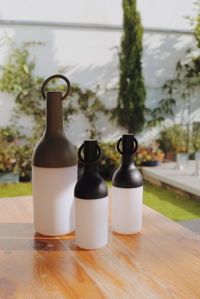 Get ready for the great outdoors with the ELO Rechargeable LED Portable Table Lamp from DesignerBox. Created with an eye toward French design by Bina Baitel, it starts with a handle that flares out into a dome shape, seating weatherproof and dimmable LED lamping inside a cylindrical, translucent shade that blocks excess glare, transforming it into a pleasant glow.