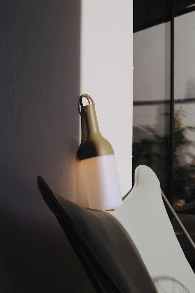 Get ready for the great outdoors with the ELO Rechargeable LED Portable Table Lamp from DesignerBox. Created with an eye toward French design by Bina Baitel, it starts with a handle that flares out into a dome shape, seating weatherproof and dimmable LED lamping inside a cylindrical, translucent shade that blocks excess glare, transforming it into a pleasant glow.