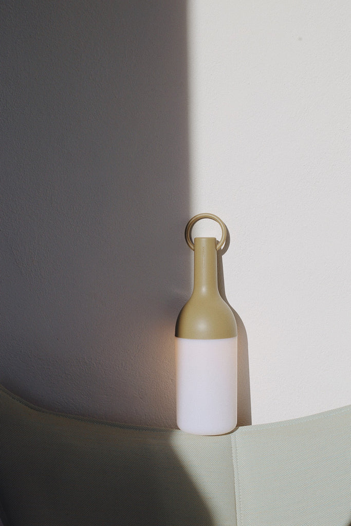 Get ready for the great outdoors with the ELO Rechargeable LED Portable Table Lamp from DesignerBox. Created with an eye toward French design by Bina Baitel, it starts with a handle that flares out into a dome shape, seating weatherproof and dimmable LED lamping inside a cylindrical, translucent shade that blocks excess glare, transforming it into a pleasant glow.