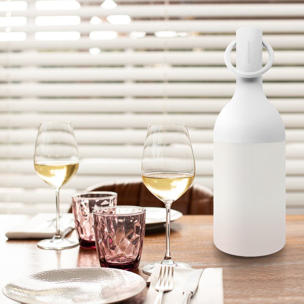 Get ready for the great outdoors with the ELO Rechargeable LED Portable Table Lamp from DesignerBox. Created with an eye toward French design by Bina Baitel, it starts with a handle that flares out into a dome shape, seating weatherproof and dimmable LED lamping inside a cylindrical, translucent shade that blocks excess glare, transforming it into a pleasant glow.