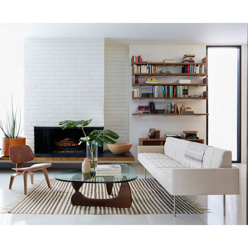 The Eames Molded Plywood Lounge Chair Wood Base (LCW) from Herman Miller in a living space.