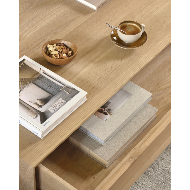 Ethnicraft's Nordic collection combines refined design with the purity of solid wood. The beveled edges give this solid oak furniture an extra edge. The Oak Nordic coffee table conveniently features one storage drawer to stash remotes, coasters, and reading.