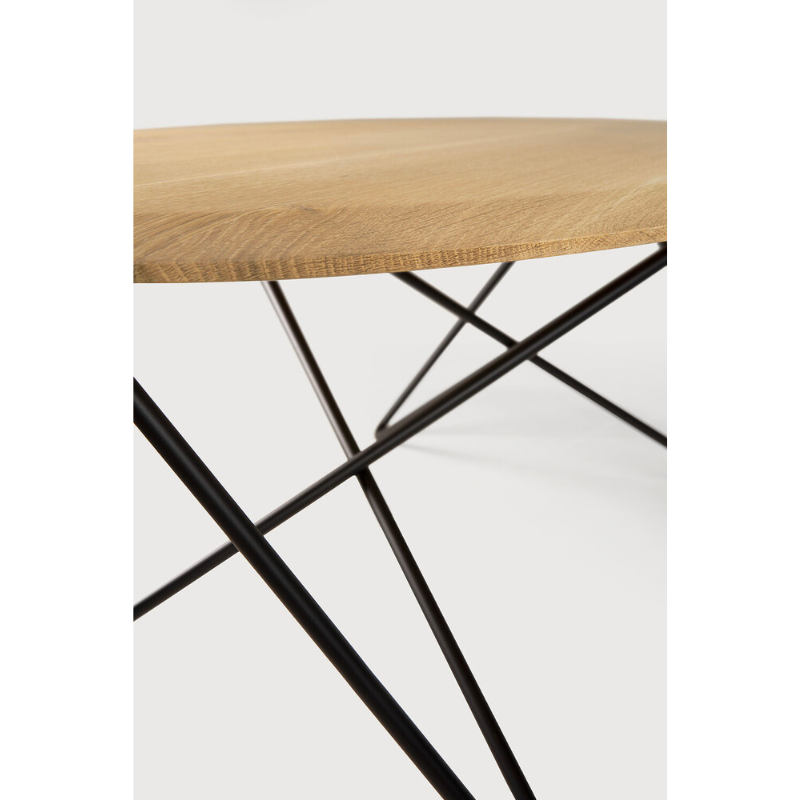 Ethnicraft's Orb is a dynamic coffee table. The shape of the top is thin on the sides and thicker in the middle. The metal legs are built in a way that they create an infinite movement, no beginning, no end, without interruption. A beautiful contrast of different lines that come together perfectly in a coffee table full of character.