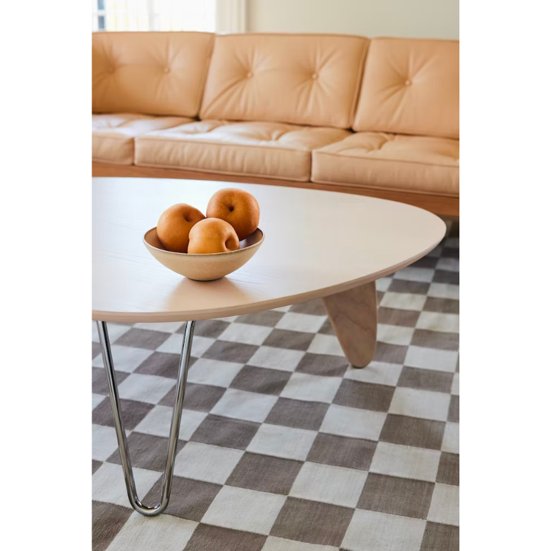 Balanced on two hairpin chrome legs and a single wooden "rudder," the wood top of the Noguchi Rudder Table (1949) seems to float airily in space. This wood and metal leg coffee table is available in three finishes and is an authentic Noguchi design created for Herman Miller.