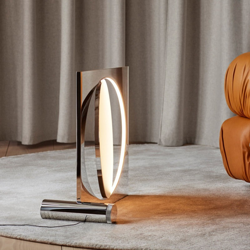 The sculptural Moonsetter floor lamp by Louis Poulsen in chrome-plated aluminum has a rotating disc that allows customization of the reflection of the glare-free light emitted by the LED light source elegantly submerged in the frame. Design by Anne Boysen.