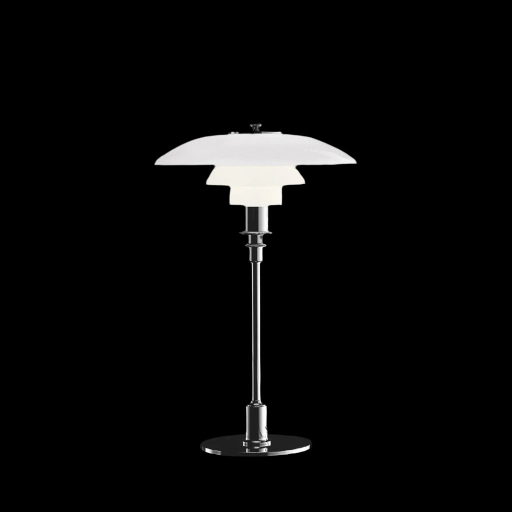 The PH 3/2 Table Light by Paul Henningsen for Louis Poulsen features a reflective three-shade system, which directs the majority of the light downwards. The shades are made of hand-blown opal three-layer glass, which is glossy on top and sandblasted matte on the underside, giving a soft and diffused light distribution.