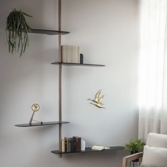 The Unica Ceiling Floating Shelving System from Nomon lends an airy, sculptural simplicity to its surroundings. An impeccably engineered Andres Martinez design that descends from above via a sleek downrod of solid walnut, it extends a series of slender, strong shelves with a smooth walnut veneer. 
