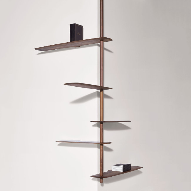 The Unica Ceiling Floating Shelving System from Nomon lends an airy, sculptural simplicity to its surroundings. An impeccably engineered Andres Martinez design that descends from above via a sleek downrod of solid walnut, it extends a series of slender, strong shelves with a smooth walnut veneer. 