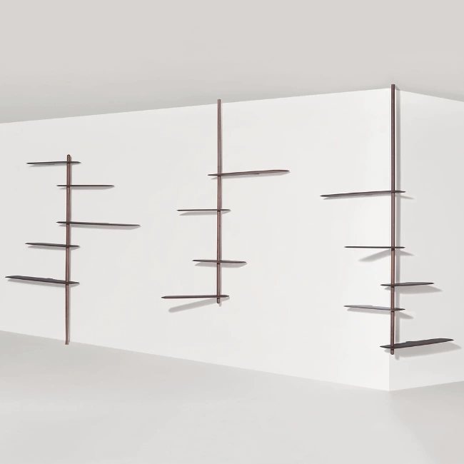 The Unica Ceiling Floating Shelving System from Nomon lends an airy, sculptural simplicity to its surroundings. An impeccably engineered Andres Martinez design that descends from above via a sleek downrod of solid walnut, it extends a series of slender, strong shelves with a smooth walnut veneer. 