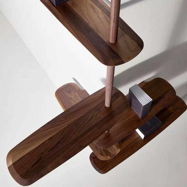 The Unica Ceiling Floating Shelving System from Nomon lends an airy, sculptural simplicity to its surroundings. An impeccably engineered Andres Martinez design that descends from above via a sleek downrod of solid walnut, it extends a series of slender, strong shelves with a smooth walnut veneer. 