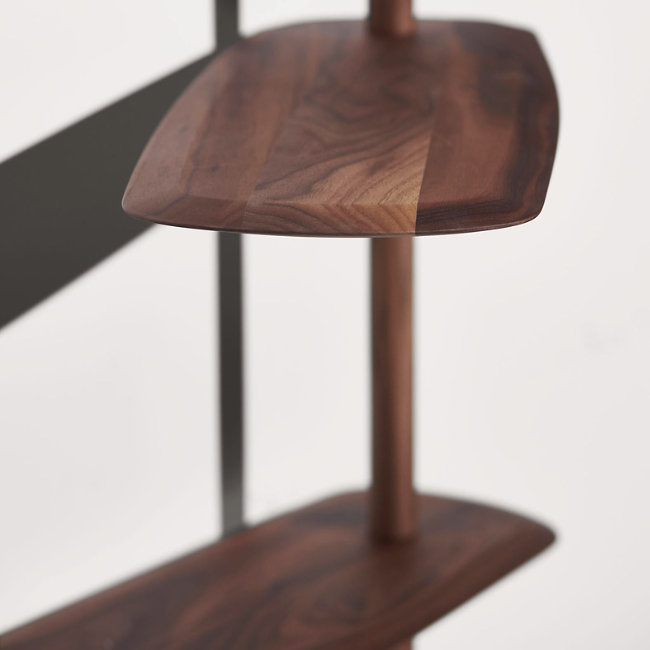Rise in style with the smooth surfaces and open expressiveness of the Unica Floor Shelving System from Nomon. A smooth design from the mind of Andres Martinez, it ascends along a single solid walnut rod that telescopes out from a narrower point, seating alternating fixed and “floating” shelves with a smooth walnut veneer along its length. 