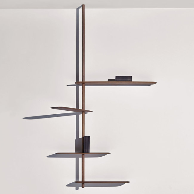 The Unica Ceiling Floating Shelving System from Nomon lends an airy, sculptural simplicity to its surroundings. An impeccably engineered Andres Martinez design that descends from above via a sleek downrod of solid walnut, it extends a series of slender, strong shelves with a smooth walnut veneer. 