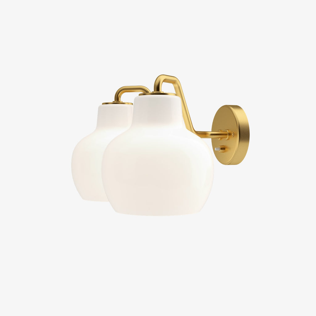The VL Ring Crown wall sconce by Louis Poulsen has a characteristically organic form that emits light directed primarily downwards, while the opal glass provides a comfortable and uniform illumination of the area around the fixture.