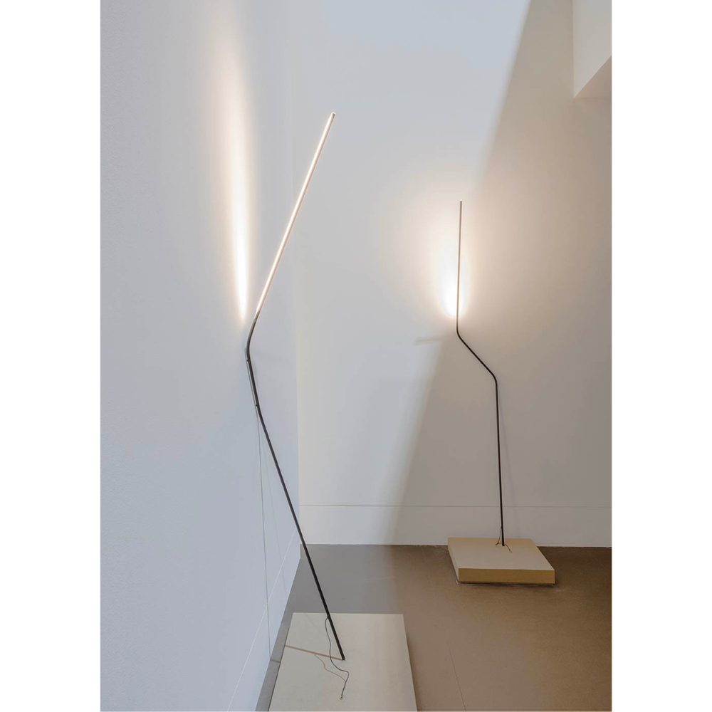 Make a statement or blend in, the NEO LED Floor Lamp, designed by Bernhard Ossan for Nemo, presents a refined fixture for modern spaces. Composed of a single steel beam, this fixture rests against the wall as a slender vertical structure.