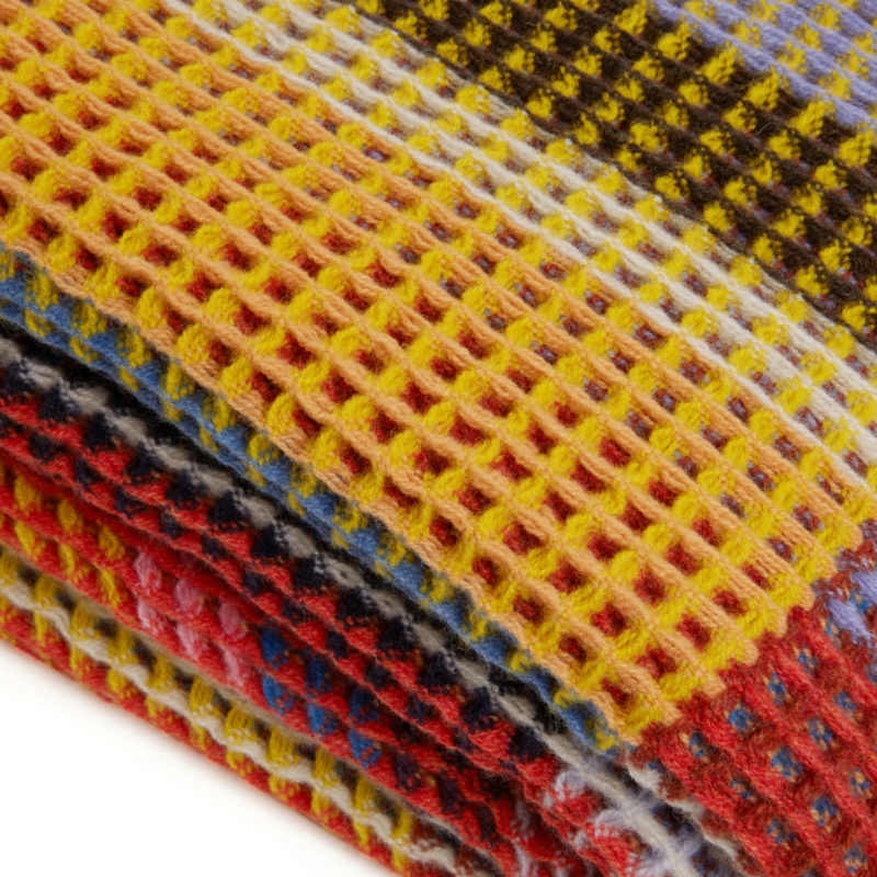 The Edith Honeycomb Throw from Wallace & Sewell made from 100% merino lambswool in the United Kingdom.