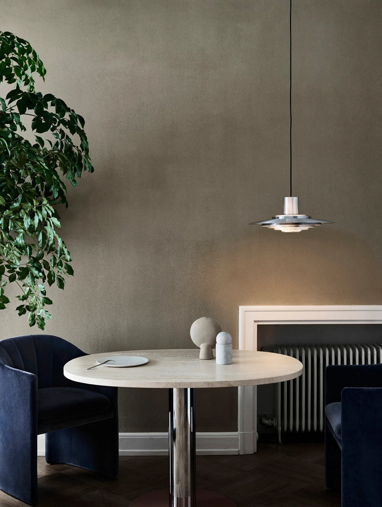 The P376 pendant lamp is a perfect example of subtle architectural slant on design. Originally conceived in 1963 by Danish architects Kastholm & Fabricius and relaunched by &Tradition in 2019, the P376 features five concentric shades that create gradations of curves towards the middle of the lamp to emit a soft, diffused light. The discrete placement of the shades and the silky aluminium finish culminate in a cohesive expression that’s both iconic and enthralling. 