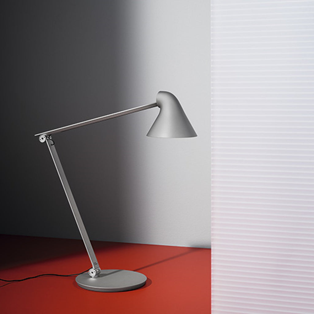 The NJP Table Lamp is a new interpretation of a classic architect lamp designed by Nendo design studio of Japan and designer Oki Sato. Its simple and honest look bares the lamp's functional components and makes it self-explanatory in its expression. The lamp features a timer function that can be set to turn the lamp off at after four or eight hours. Its ergonomic design and simple mechanical system provides great freedom of movement, so that light can always be set in the ideal position in the workspace.