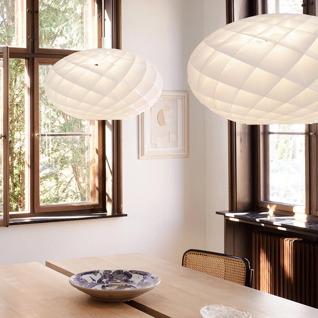 The timeless Patera Oval Pendant follows the same elegant design principles as the circular Patera Pendant and is assembled entirely by hand. Danish designer Øivind Slaatto took inspiration from the Fibonacci spiral and designed the pendant to following the mathematic structure of the captivating Fibonacci spiral.