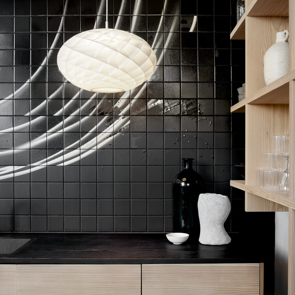 The timeless Patera Oval Pendant follows the same elegant design principles as the circular Patera Pendant and is assembled entirely by hand. Danish designer Øivind Slaatto took inspiration from the Fibonacci spiral and designed the pendant to following the mathematic structure of the captivating Fibonacci spiral.