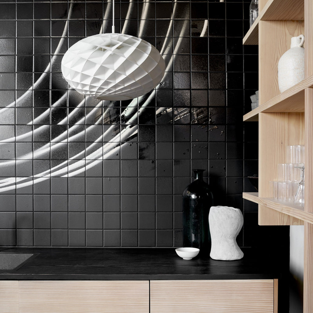 The timeless Patera Oval Pendant follows the same elegant design principles as the circular Patera Pendant and is assembled entirely by hand. Danish designer Øivind Slaatto took inspiration from the Fibonacci spiral and designed the pendant to following the mathematic structure of the captivating Fibonacci spiral.