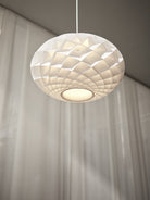 The timeless Patera Oval Pendant follows the same elegant design principles as the circular Patera Pendant and is assembled entirely by hand. Danish designer Øivind Slaatto took inspiration from the Fibonacci spiral and designed the pendant to following the mathematic structure of the captivating Fibonacci spiral.