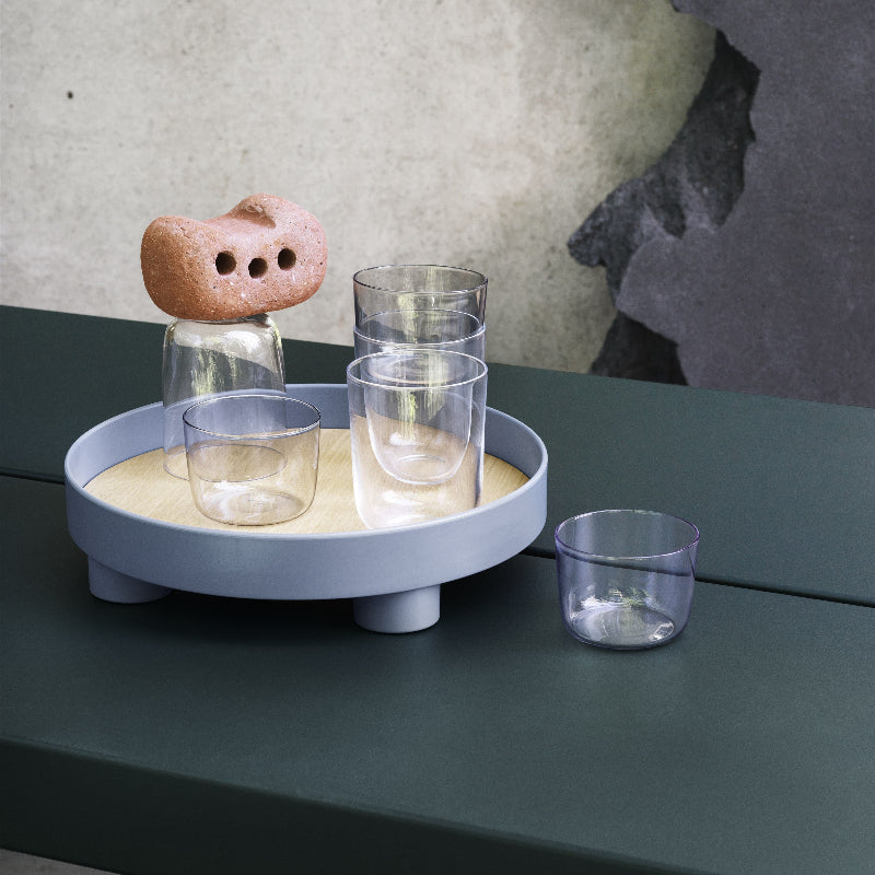 The Platform Tray by Muuto in blue gray used as a drink tray.