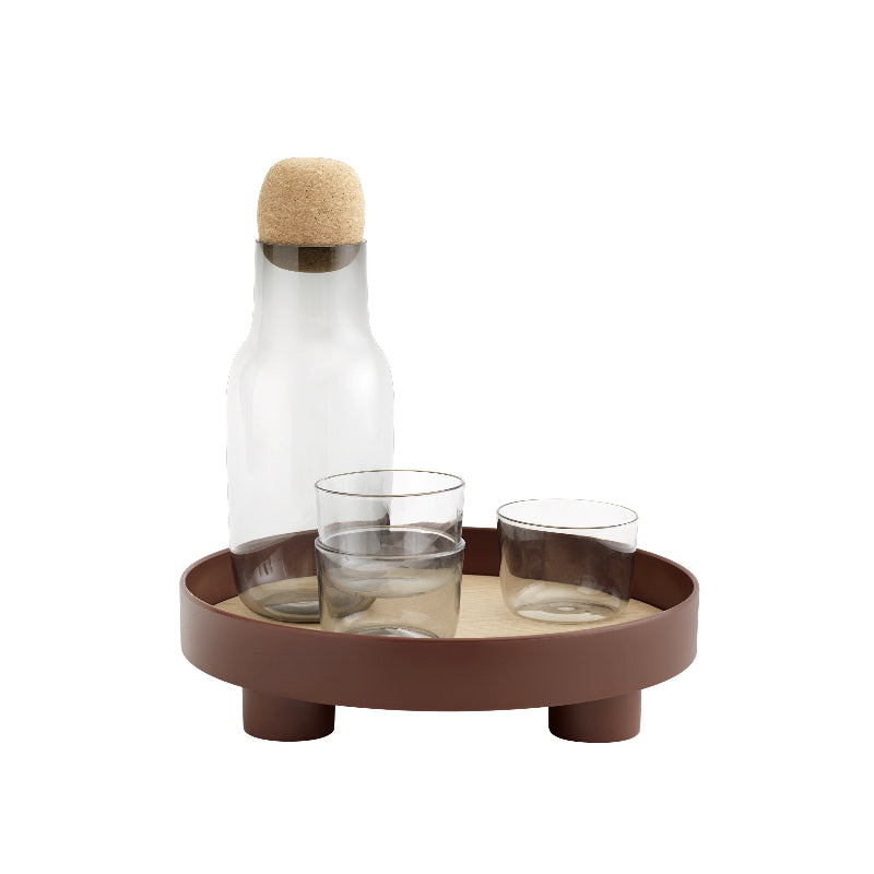 The Platform Tray by Muuto in deep red with a drink setup.