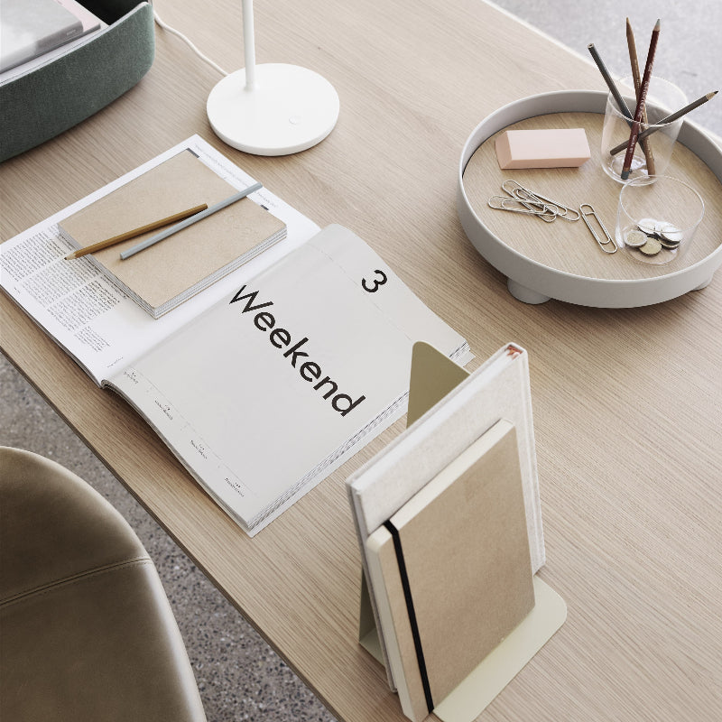 The Platform Tray by Muuto in gray in a home office.