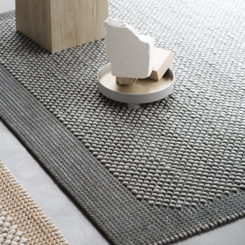 The Platform Tray by Muuto in gray in a living room.