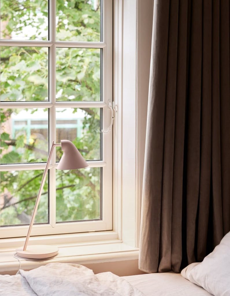 The NJP Mini Table Lamp is a petite version of the NJP Table Lamp with downscaled proportions. Both are a modernistic take on the classic architect lamp with the flexibility of two joints on the extensive arm. The characteristic rear-shade opening toward the arm allows stemless adjustment of the organic head. Designed by Nendo Japanese design studio and designer Oki Sato. 